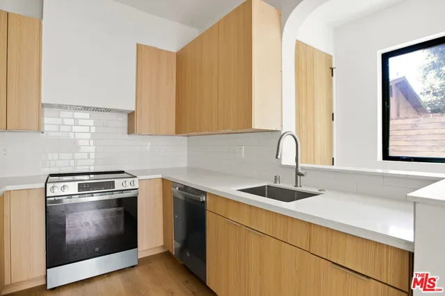 a kitchen with sink a microwave and stove