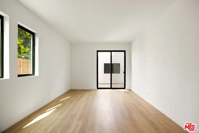 a bedroom with bed and flat screen tv