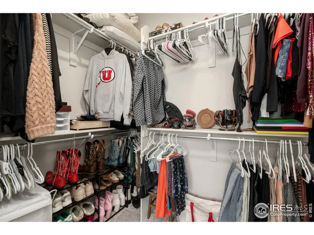 a view of walk in closet with clothes