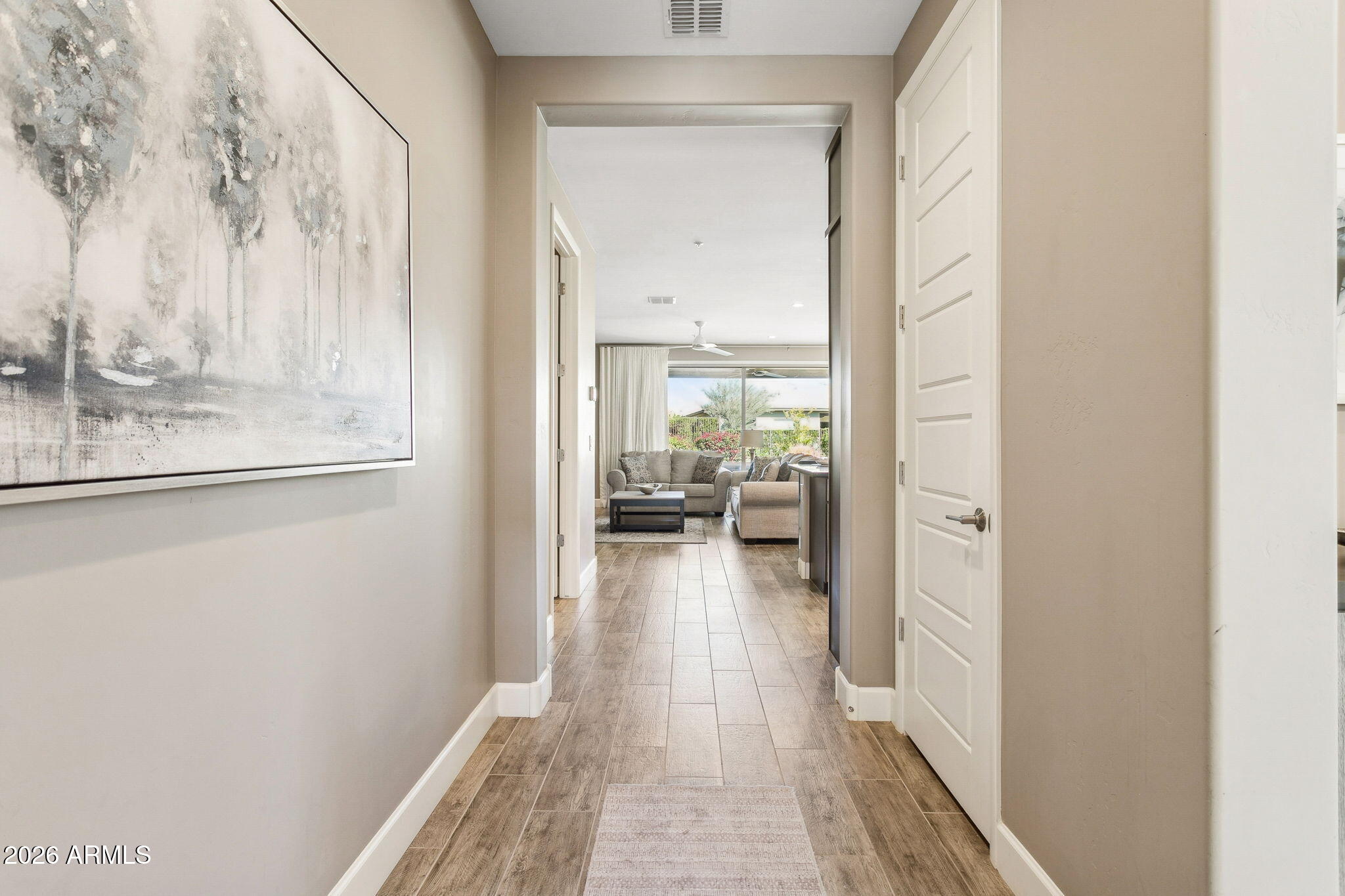 17660 East Fort Verde Road Rio Verde, AZ 85263 - Photo 5 of 56 a view of a hallway with a livingroom and a dinning room with furniture