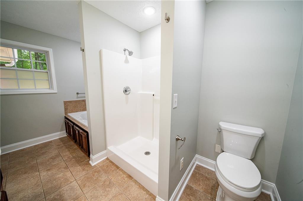 1927 Lee Road Salem, AL 36874 - Photo 36 of 45 Full bathroom featuring light tile patterned flooring and a shower stall