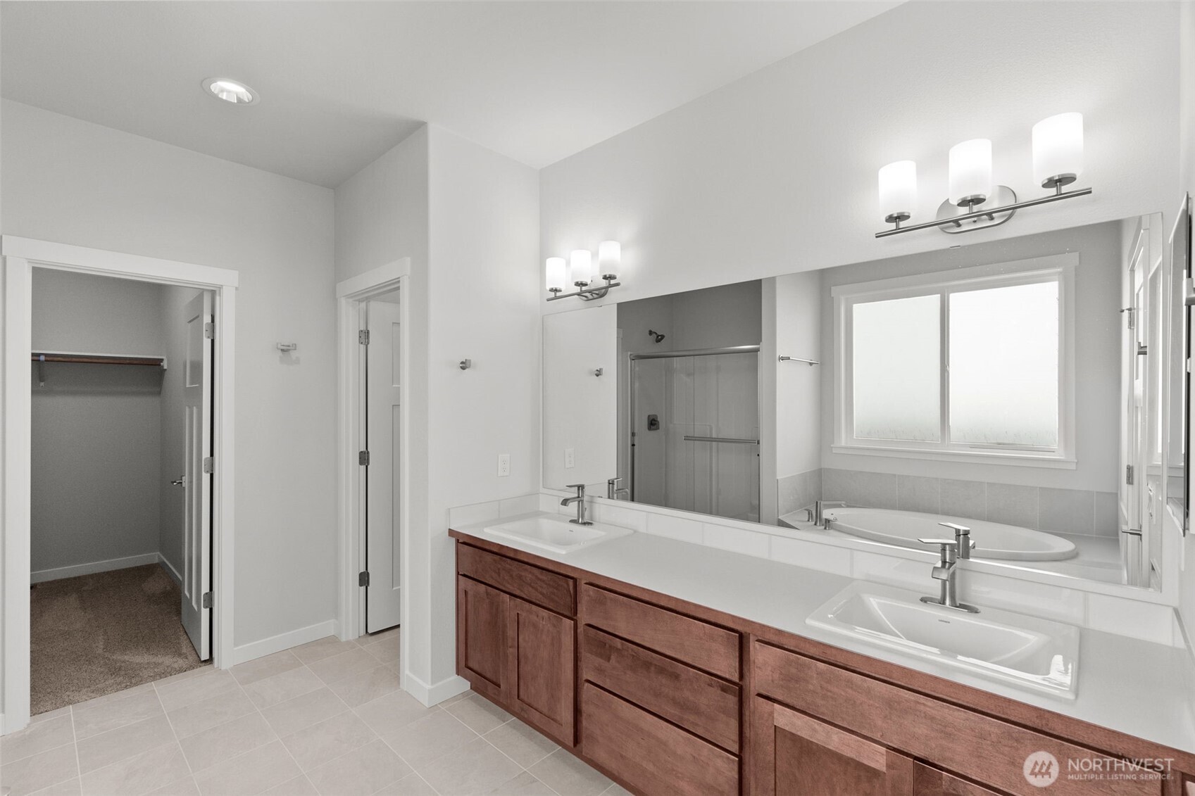 637 Maggee Street Southeast Lacey, WA 98513 - Photo 11 of 34 a bathroom with double vanity sinks a vanity a lamp and a mirror