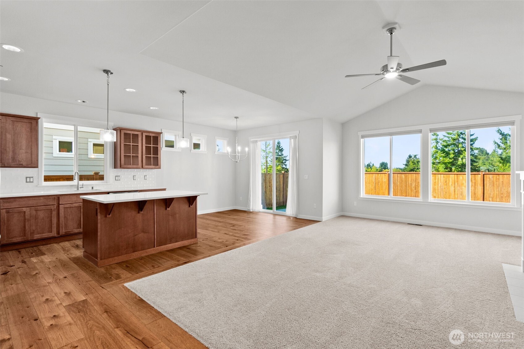 637 Maggee Street Southeast Lacey, WA 98513 - Photo 17 of 34 a large kitchen with stainless steel appliances granite countertop a stove a sink a refrigerator and a dining table with wooden floor