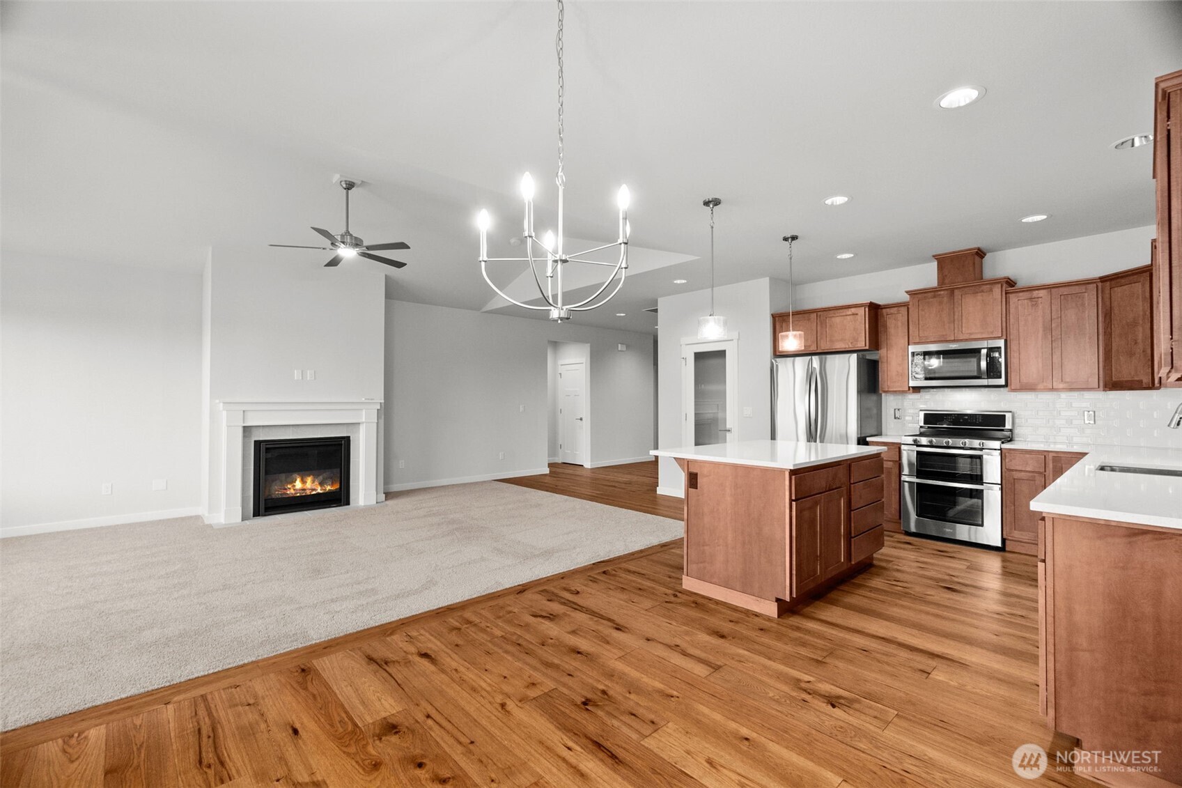 637 Maggee Street Southeast Lacey, WA 98513 - Photo 19 of 34 a large kitchen with granite countertop a stove top oven a sink dishwasher a dining table and chairs with wooden floor