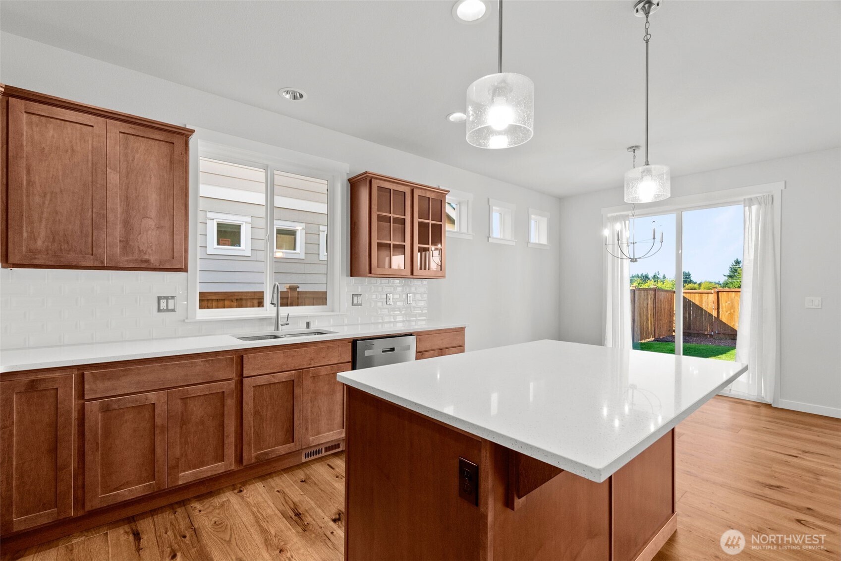 637 Maggee Street Southeast Lacey, WA 98513 - Photo 21 of 34 a kitchen with a stove a sink dishwasher and a refrigerator with wooden floor