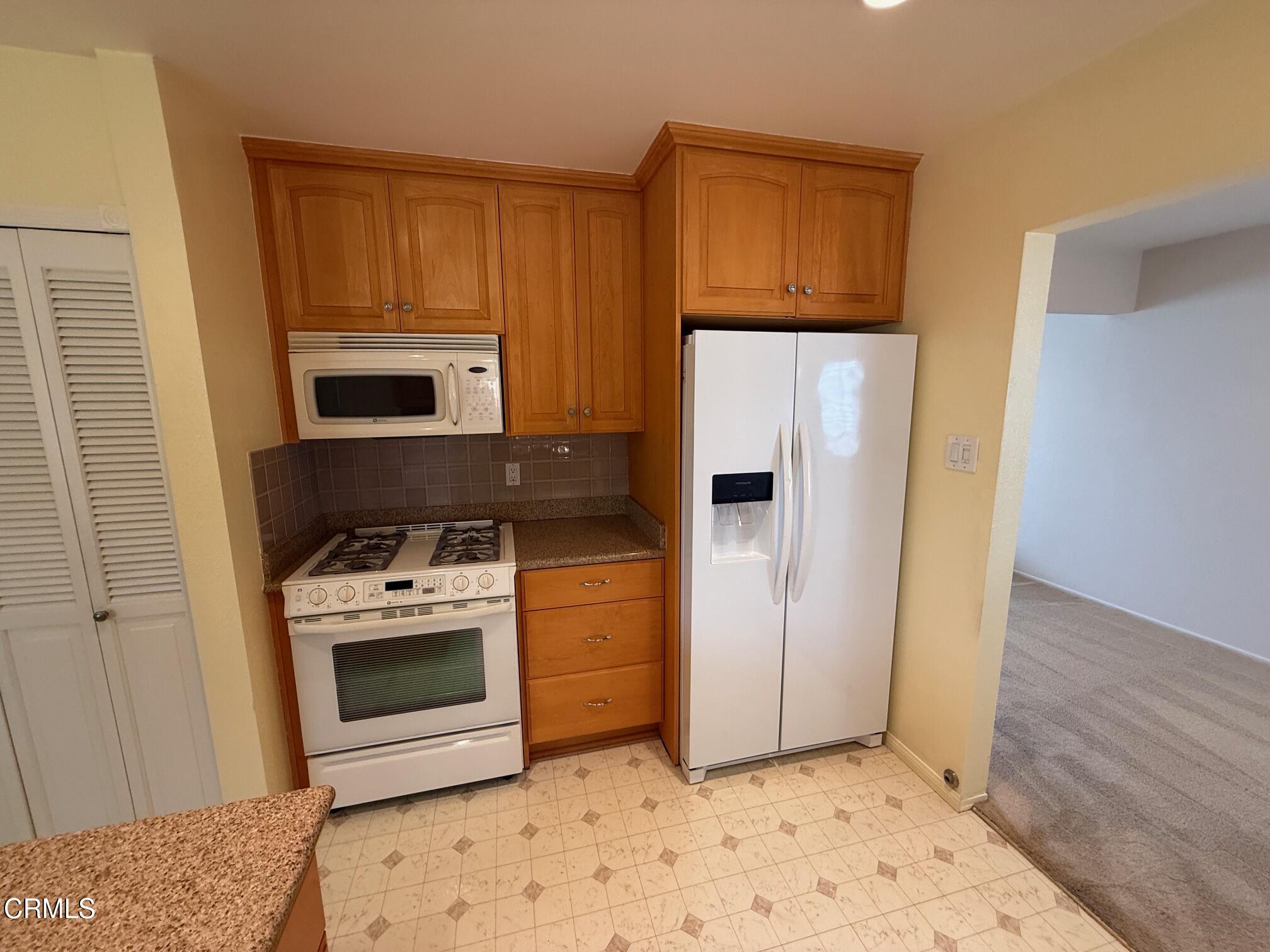 545 Pearson Road Port Hueneme, CA 93041 - Photo 10 of 19 a kitchen with a stove a refrigerator and cabinets