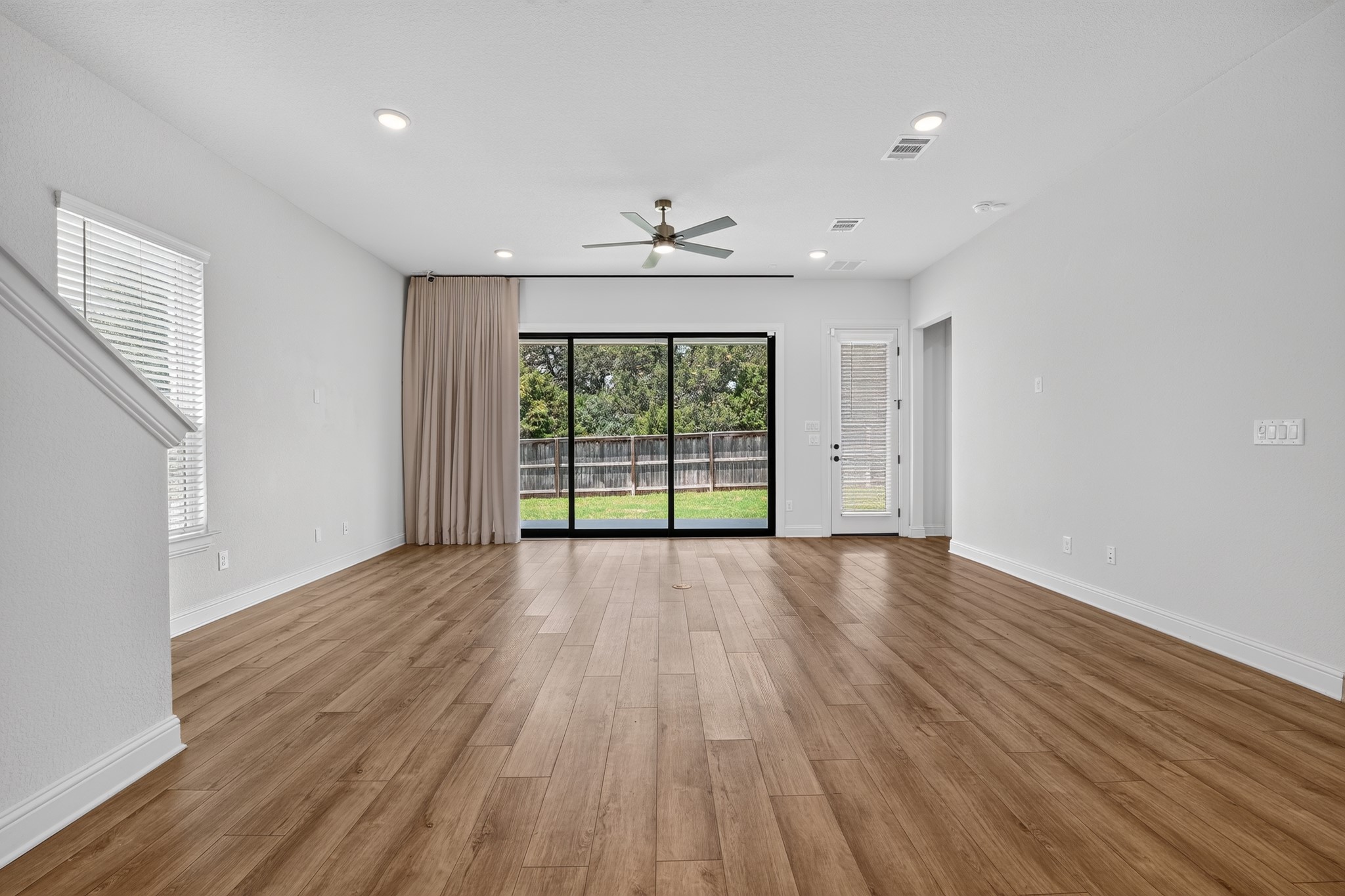 508 Pinnacle View Drive Georgetown, TX 78628 - Photo 2 of 27 An inviting open-concept living space features warm wood-look flooring and a view of the private yard.