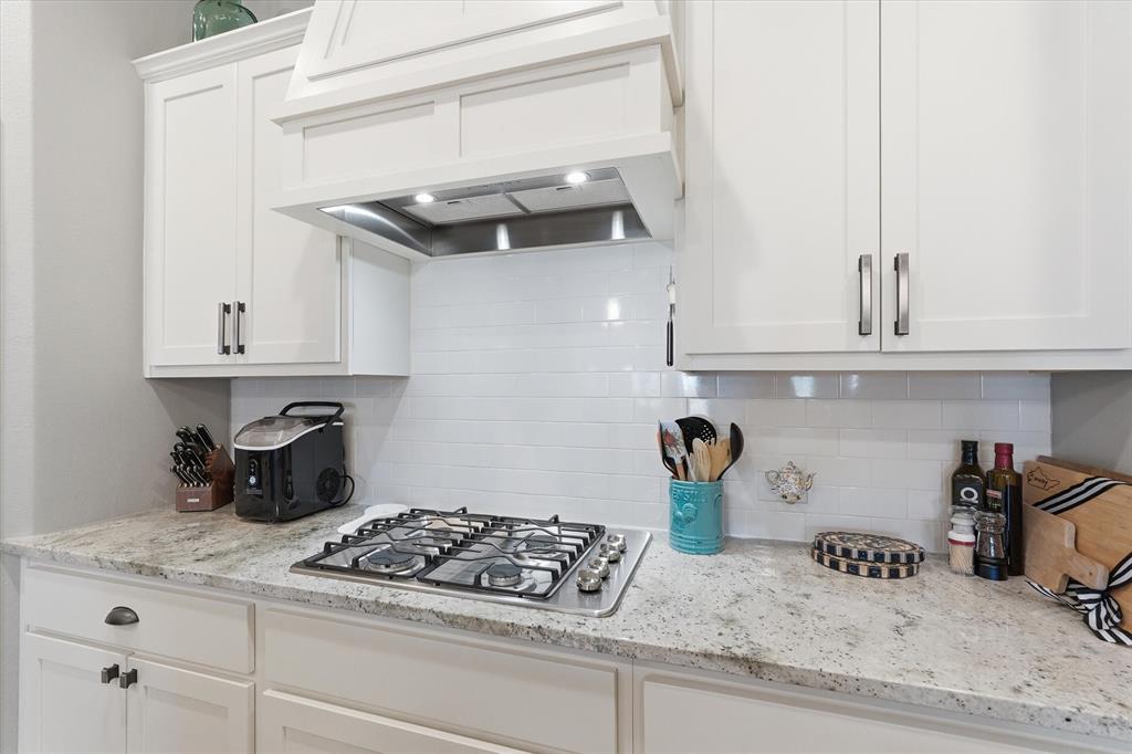 813 Mildren Lane Fate, TX 75087 - Photo 7 of 32 Close up of gas cooktop, abundant cabinets and countertop space!
