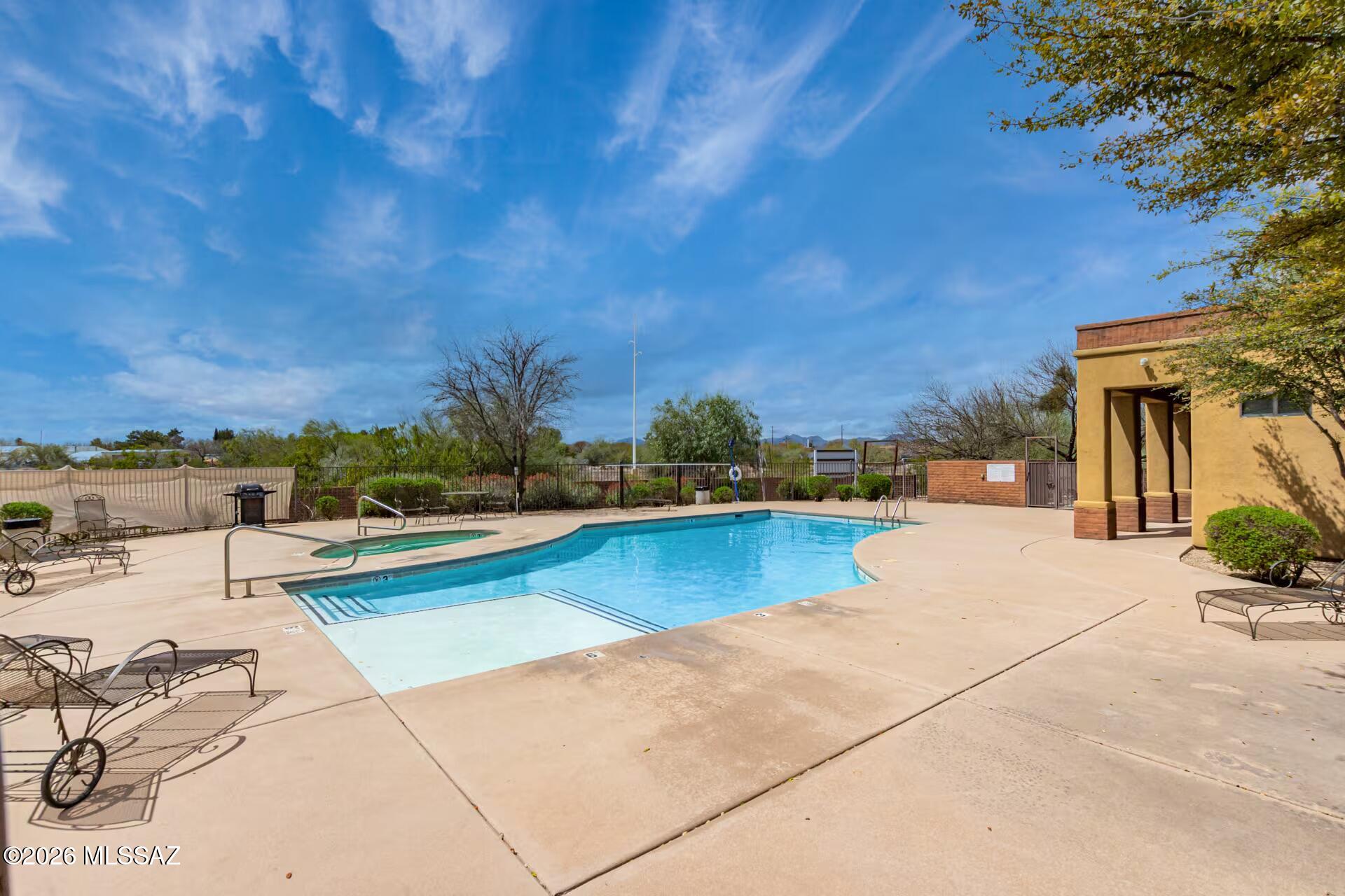 2036 East River Road, Unit 104 Tucson, AZ 85718 - Photo 23 of 23 a view of a swimming pool with lounge chairs