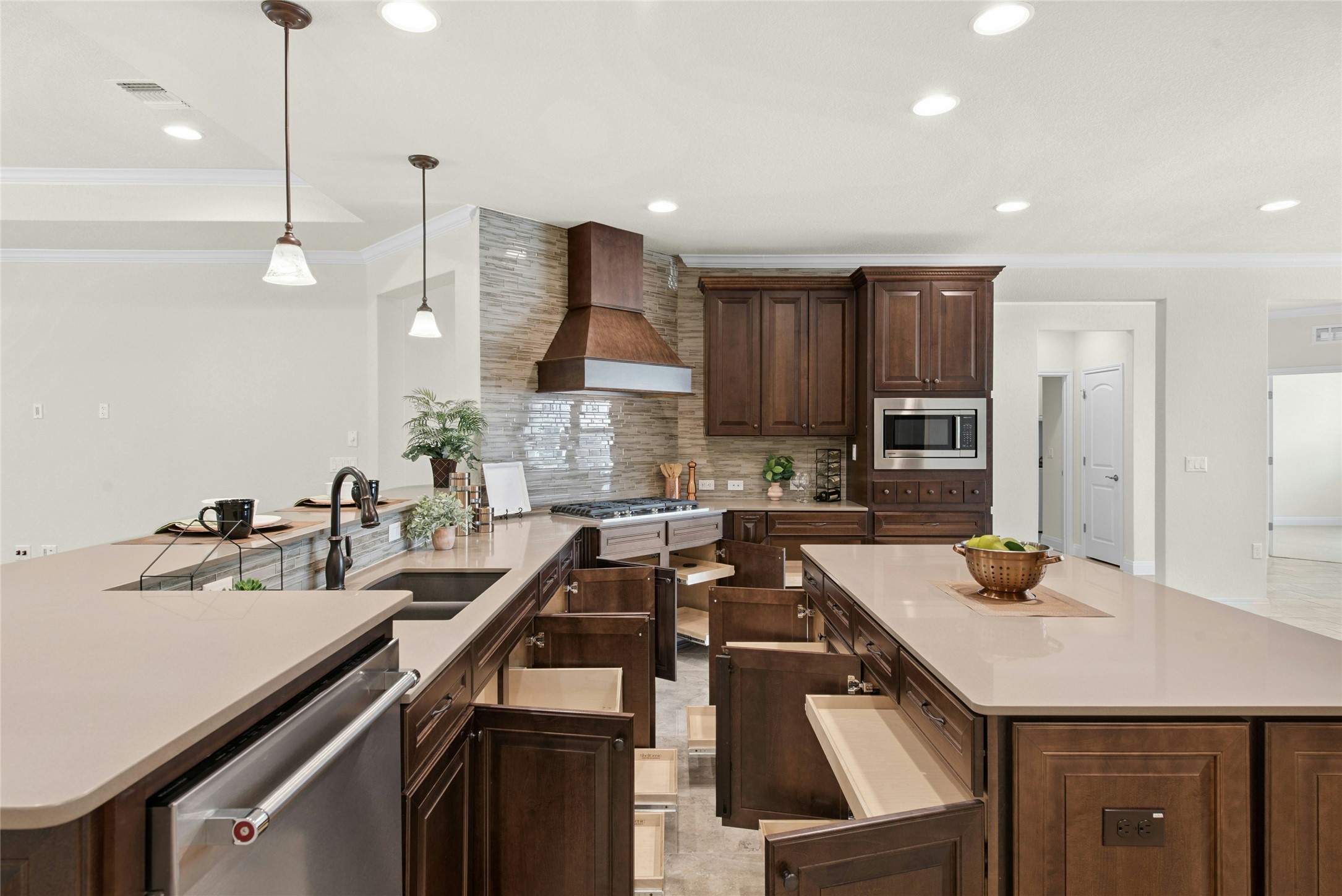 105 Marfa Cove Georgetown, TX 78633 - Photo 14 of 36 a kitchen with a sink a counter and chairs in it