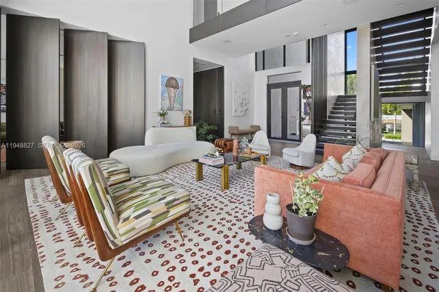 a living room with furniture large window and book shelf