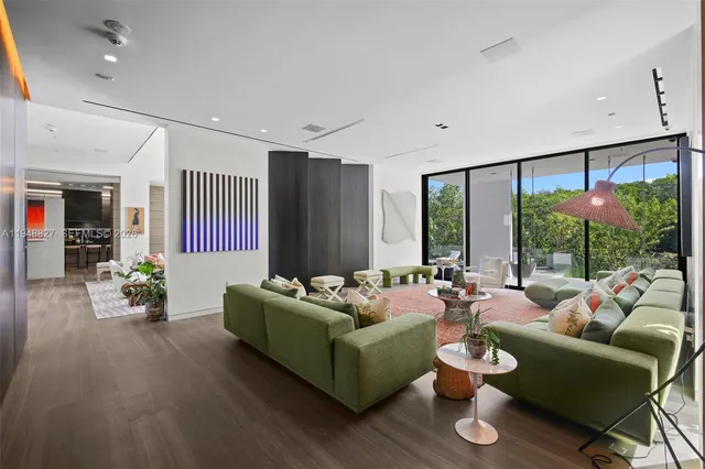 a large kitchen with stainless steel appliances a large counter top a stove and a refrigerator