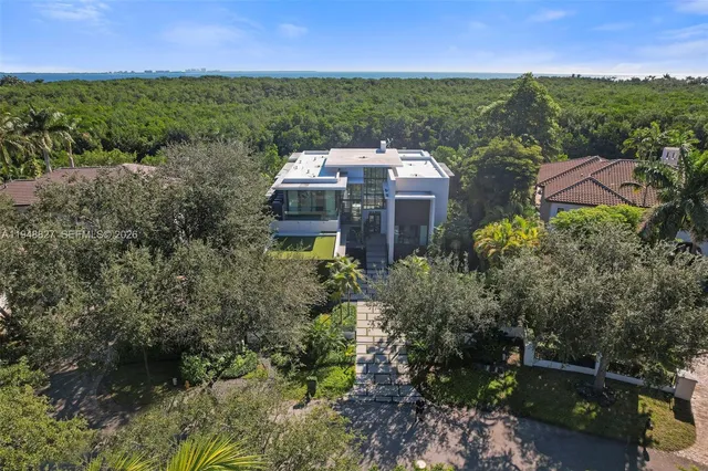 a living room with furniture and floor to ceiling windows