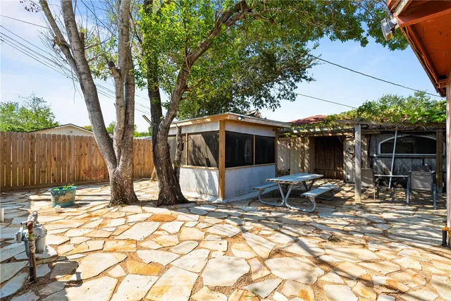 a backyard of a house with table and chairs