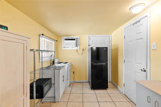 a kitchen with a refrigerator and cabinets