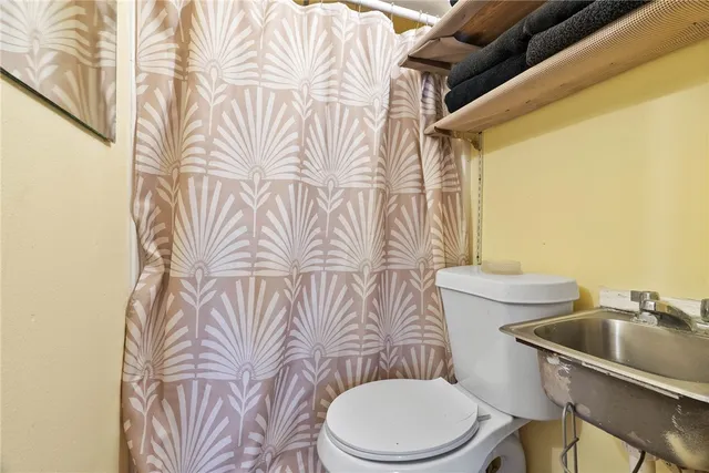a white toilet sitting next to a bathroom sink