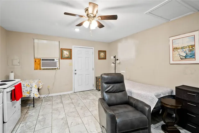 a living room with furniture and a air conditioner vent