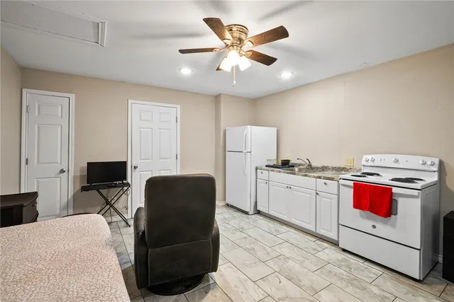 a living room with furniture and kitchen view
