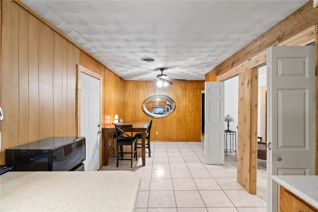 a living room with furniture a dining table and a large window