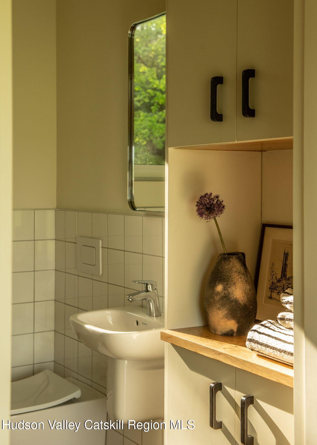 346 Cold Spring Road Hudson, NY 12534 - Photo 15 of 25 a bathroom with a sink and a mirror