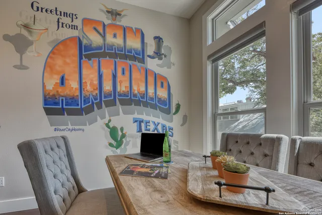 a living room with furniture a fireplace and a floor to ceiling window