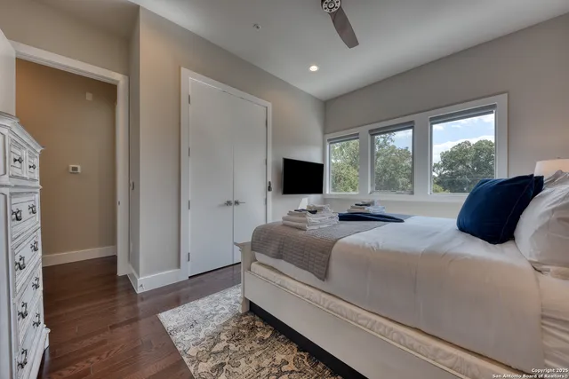 a bedroom with a bed and a flat screen tv