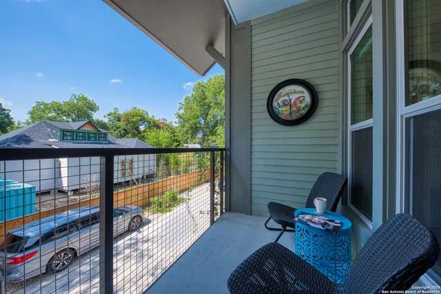 a view of a two chairs and table in a balcony