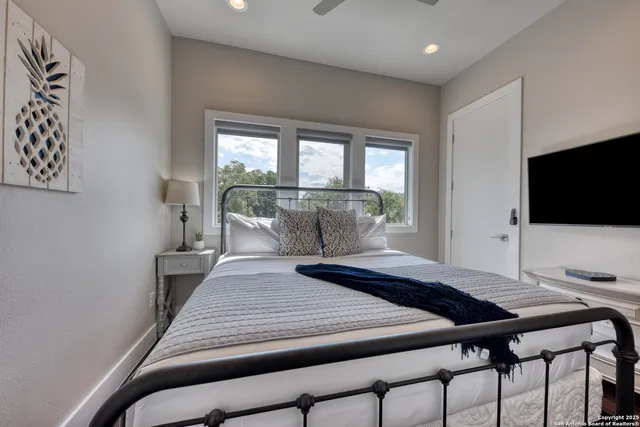a bedroom with a bed and a flat screen tv