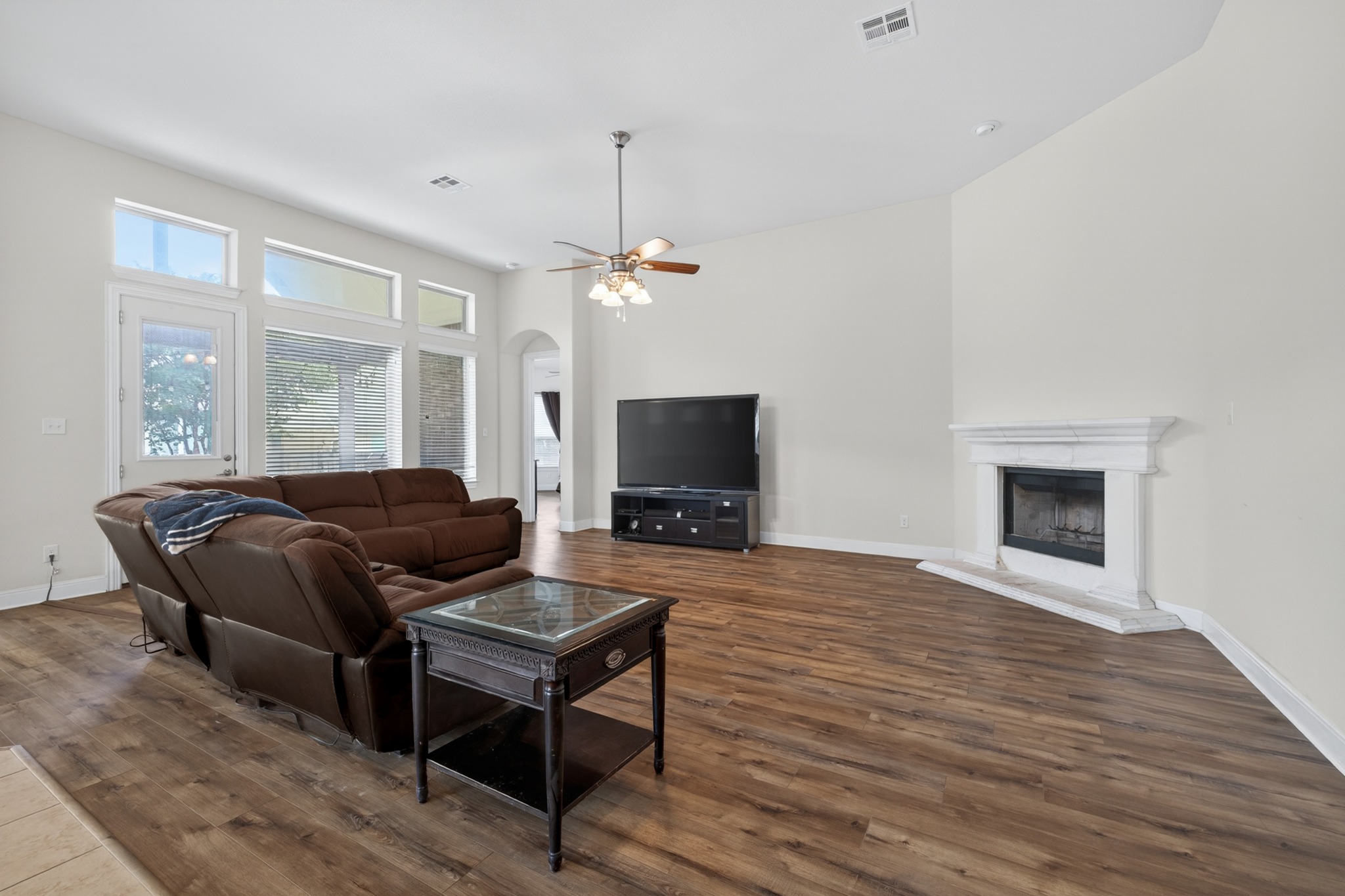 1017 Tabernash Leander, TX 78641 - Photo 16 of 38 Living area featuring wood-finish flooring and a corner fireplace with a white mantel and hearth