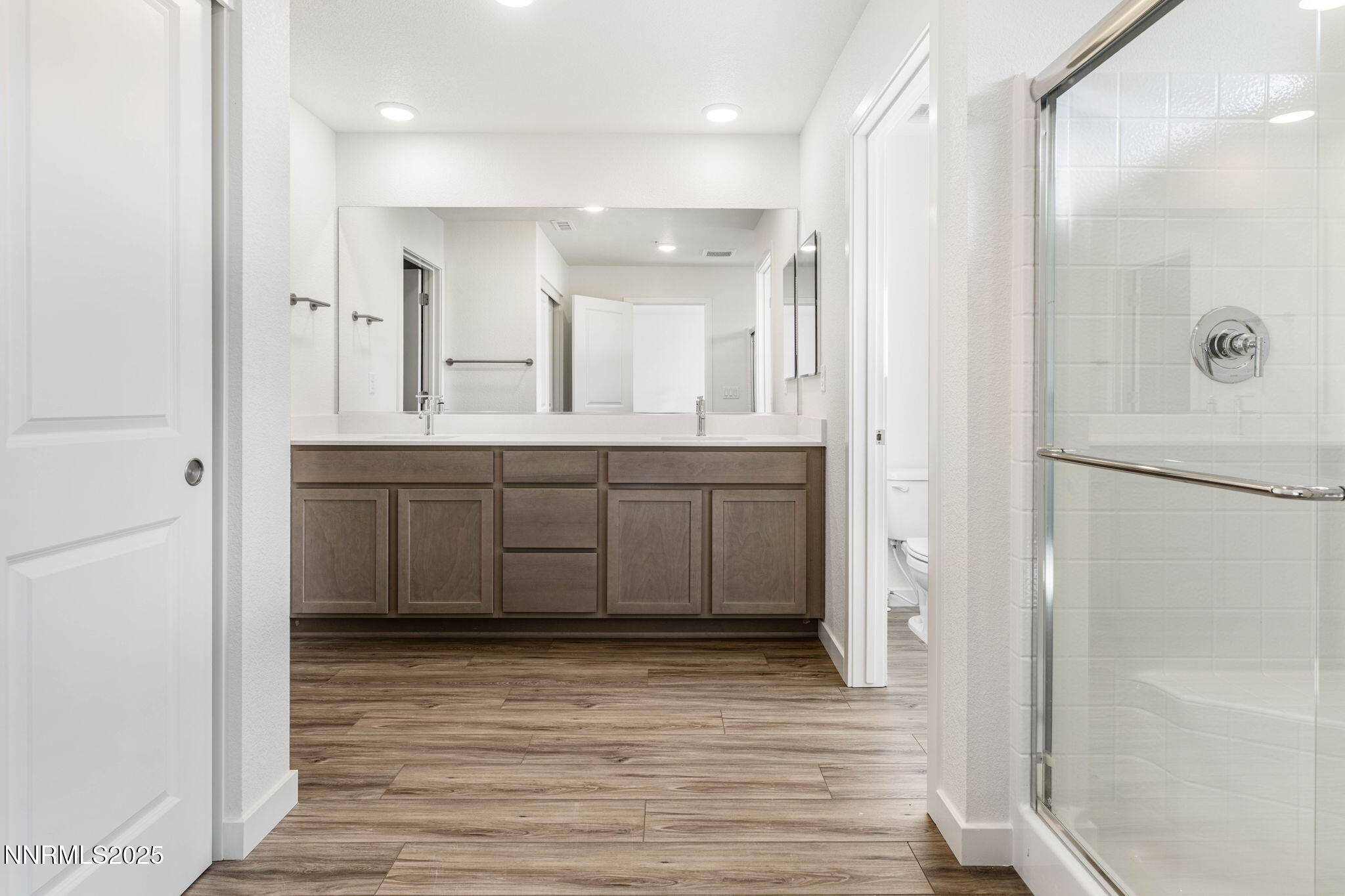 345 Halite Drive Dayton, NV 89403 - Photo 11 of 24 a bathroom with a double vanity sink a mirror and a shower