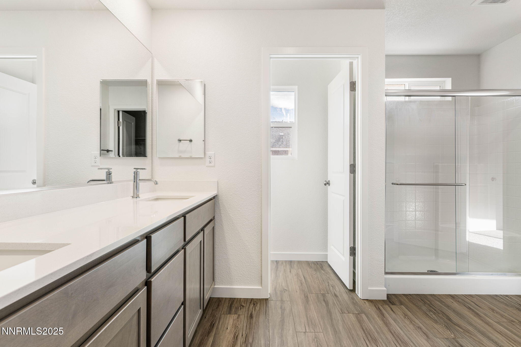 345 Halite Drive Dayton, NV 89403 - Photo 12 of 24 a bathroom with a sink a mirror and shower