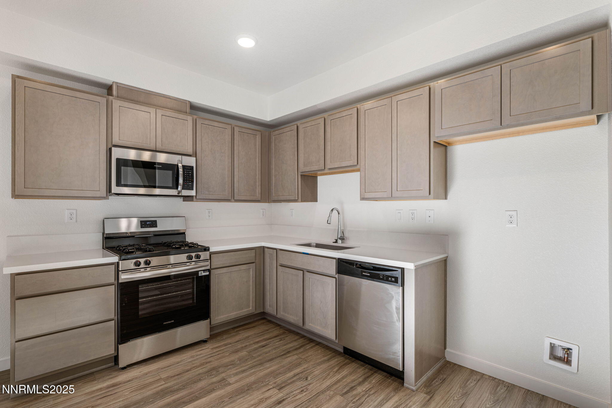 345 Halite Drive Dayton, NV 89403 - Photo 6 of 24 a kitchen with granite countertop white cabinets stainless steel appliances and sink