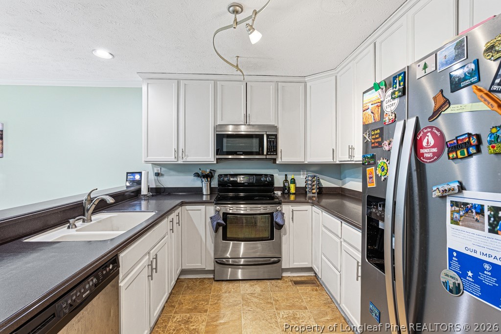 461 Lands End Road Fayetteville, NC 28314 - Photo 8 of 31 a kitchen with stainless steel appliances granite countertop a sink and a stove