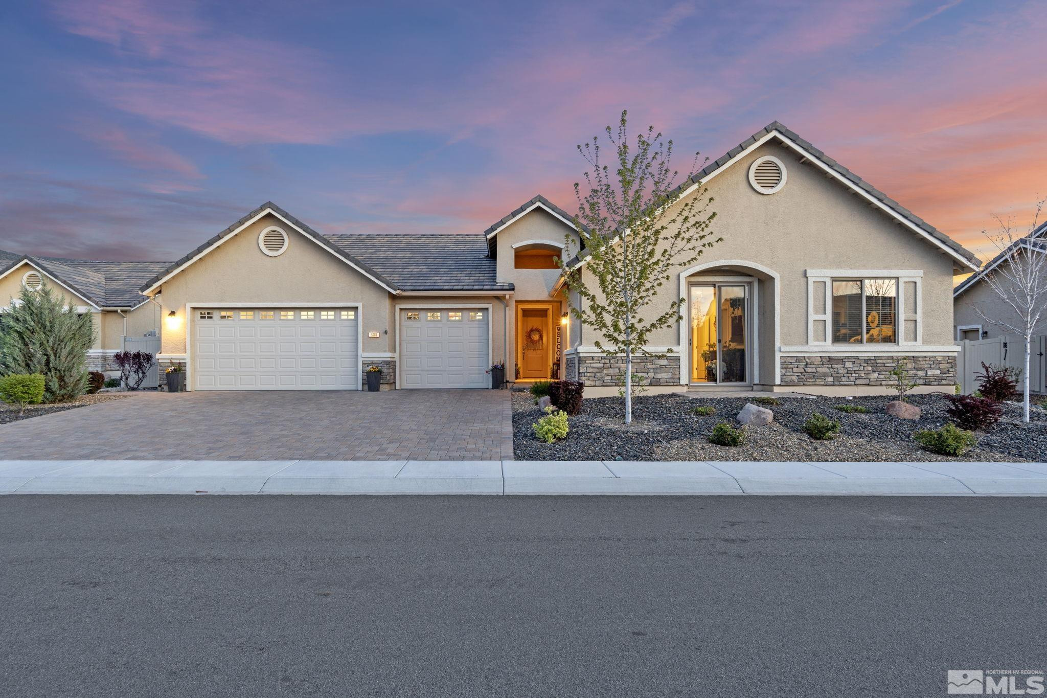 a front view of a house with a yard and garage