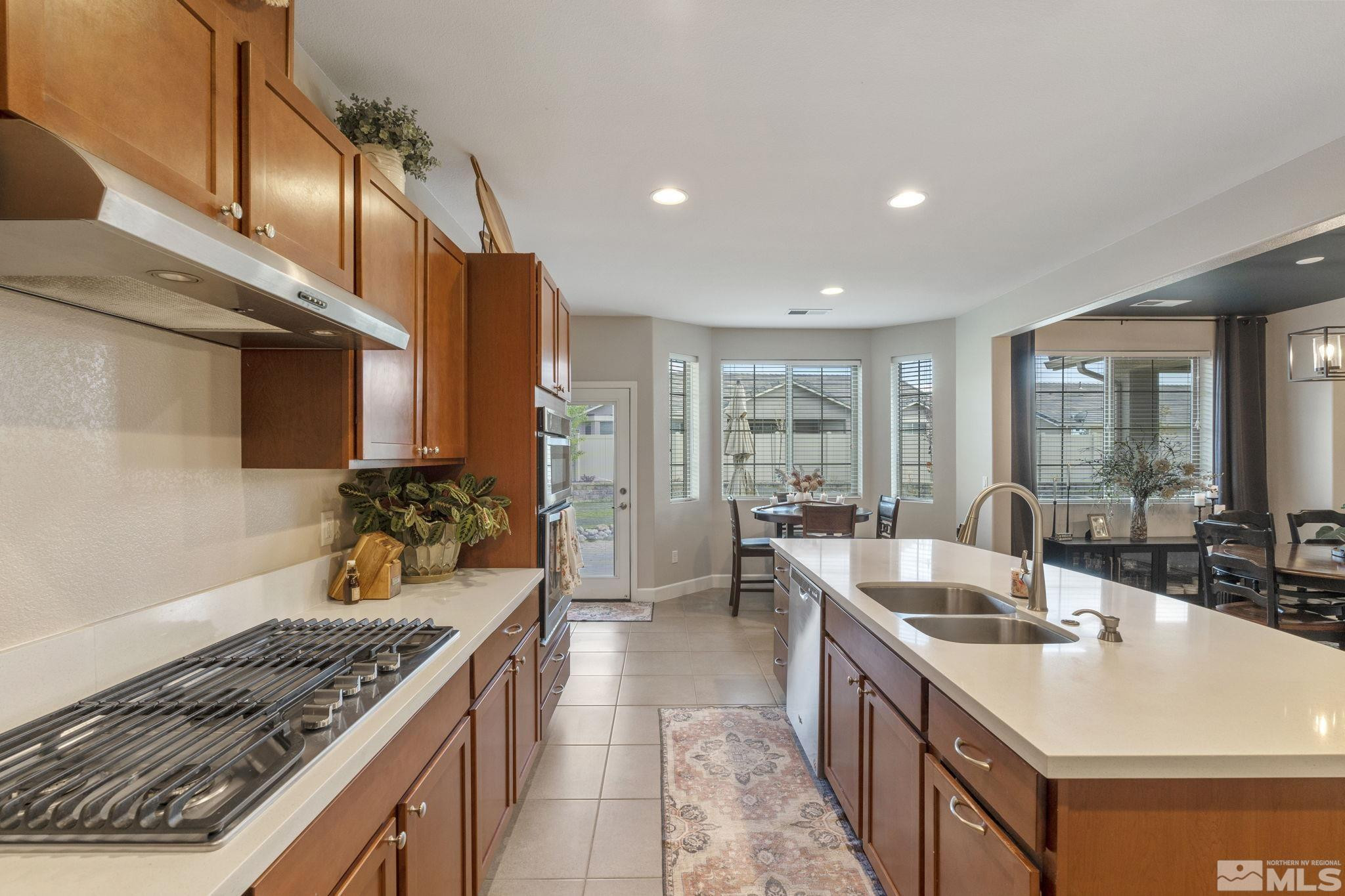 508 Alpine Rose Ct. Reno, NV 89521 - Photo 11 of 39 a kitchen with stainless steel appliances granite countertop a sink and a stove