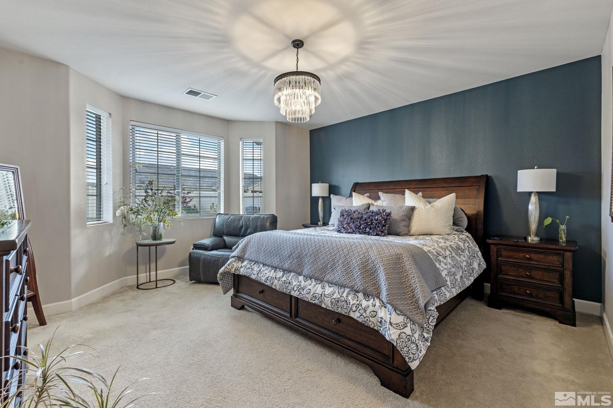 508 Alpine Rose Ct. Reno, NV 89521 - Photo 19 of 39 a spacious bedroom with a bed and a table in it