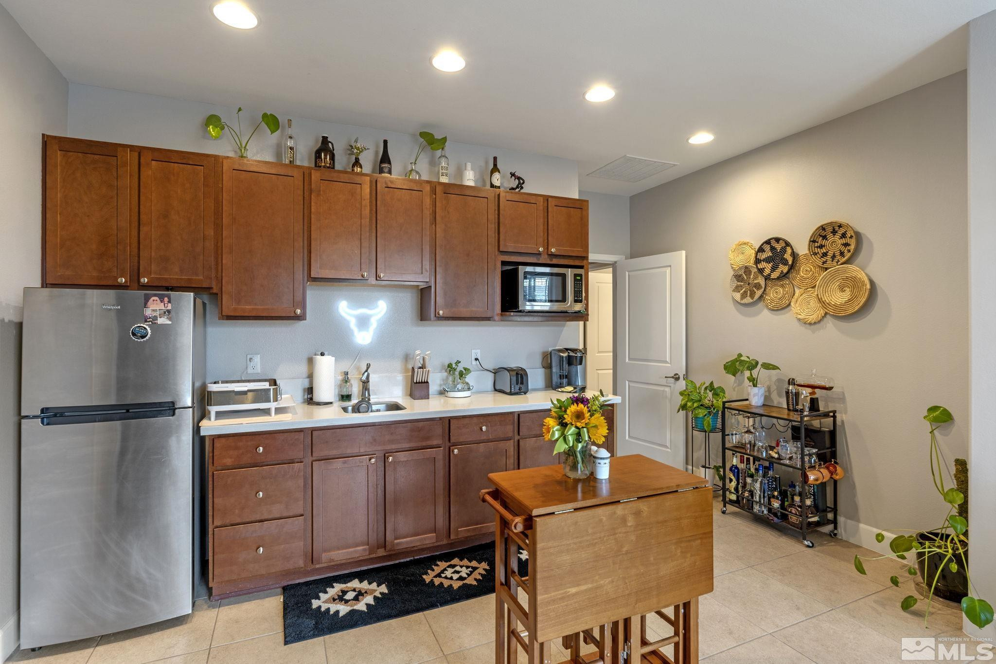 508 Alpine Rose Ct. Reno, NV 89521 - Photo 24 of 39 a kitchen with stainless steel appliances granite countertop a refrigerator and a stove top oven