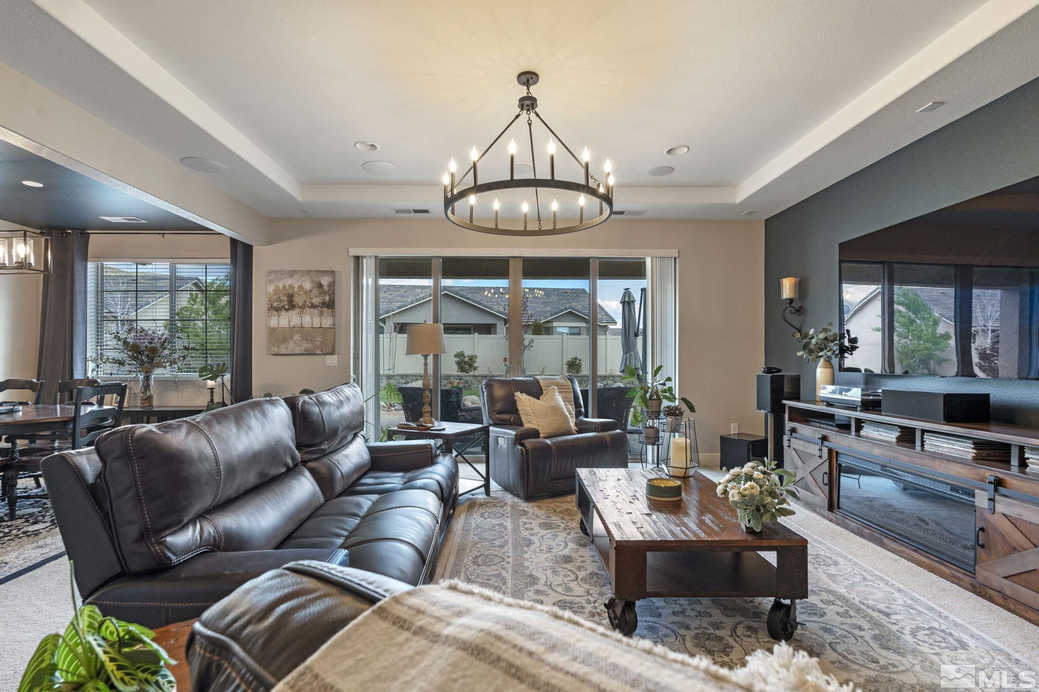 508 Alpine Rose Ct. Reno, NV 89521 - Photo 8 of 39 a living room with furniture a large window and a chandelier
