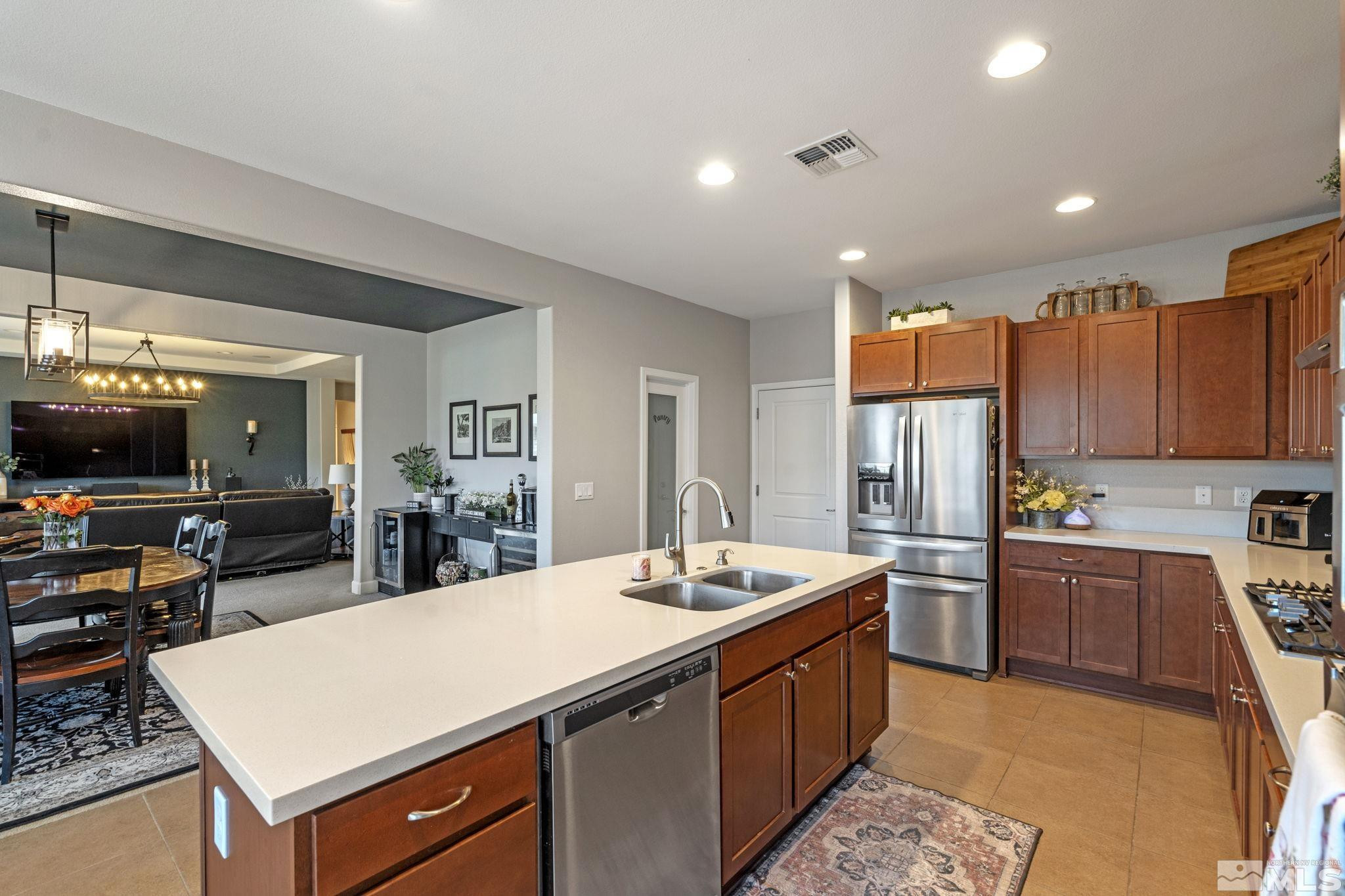 508 Alpine Rose Ct. Reno, NV 89521 - Photo 10 of 39 a kitchen with stainless steel appliances kitchen island granite countertop a sink and a refrigerator