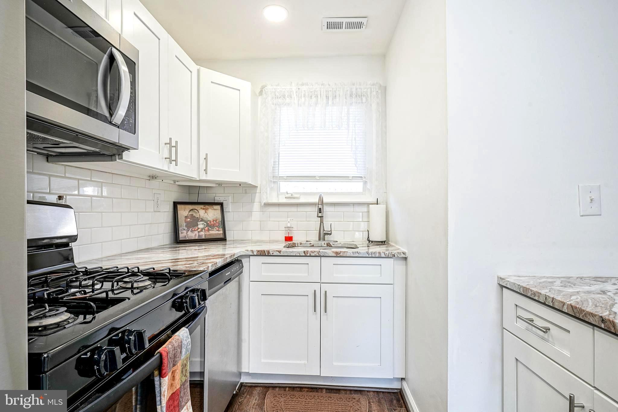 5 Via Cascata Drive Clementon, NJ 08021 - Photo 14 of 26 a kitchen with stainless steel appliances granite countertop a stove and a sink