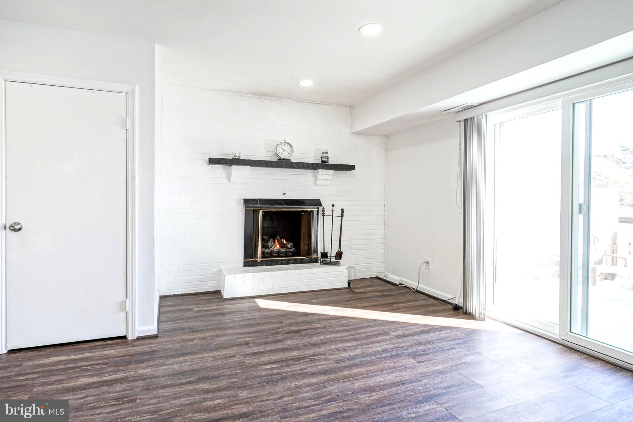 5 Via Cascata Drive Clementon, NJ 08021 - Photo 16 of 26 an empty room with wooden floor and a fireplace