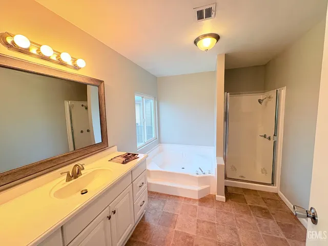 a bathroom with a tub sink and mirror