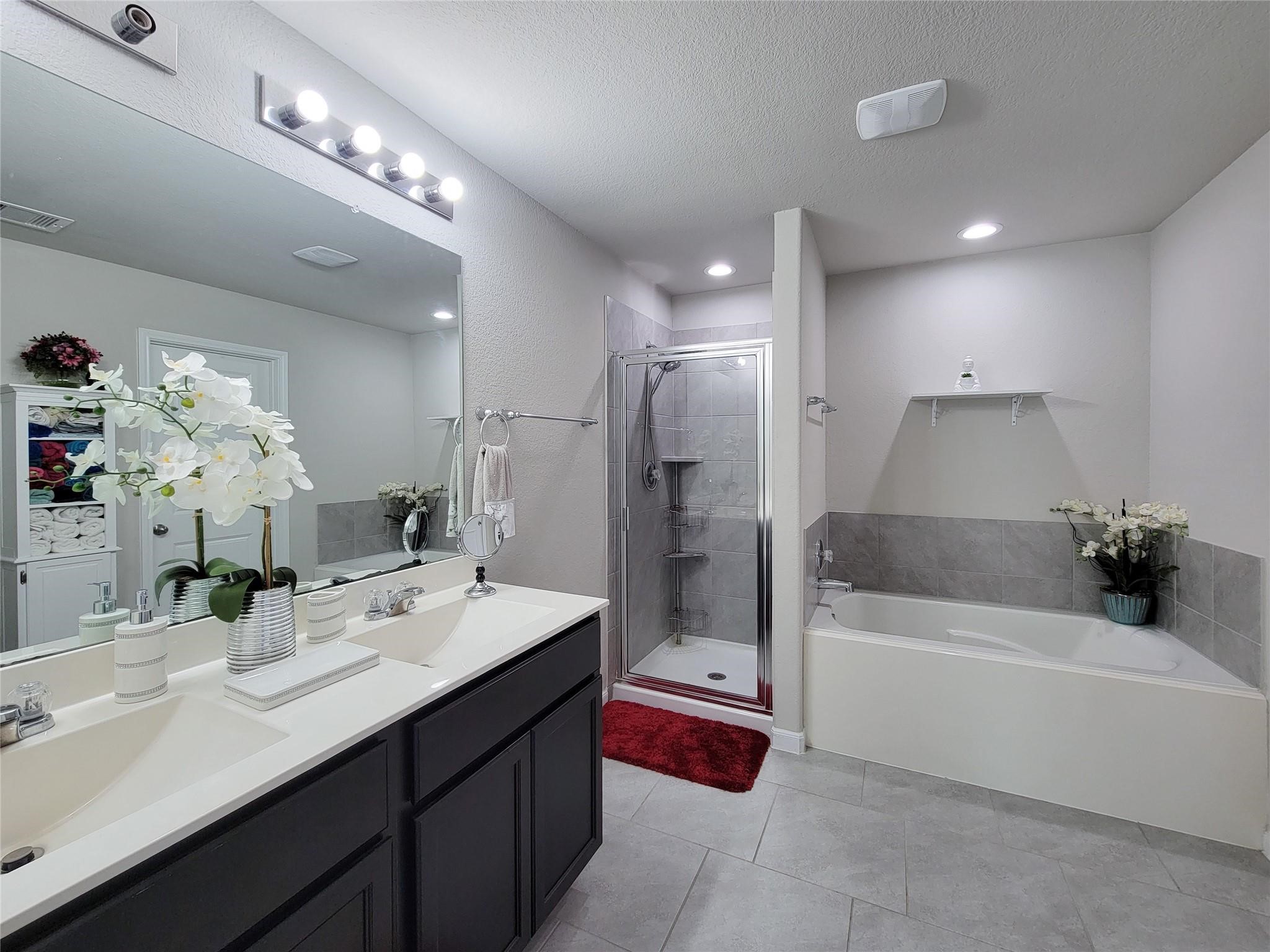 610 Autumn Flats Way Rosharon, TX 77583 - Photo 1 of 25 Lovely and relaxing master bathroom, equipped with a double vanity, walk in shower and large tub.