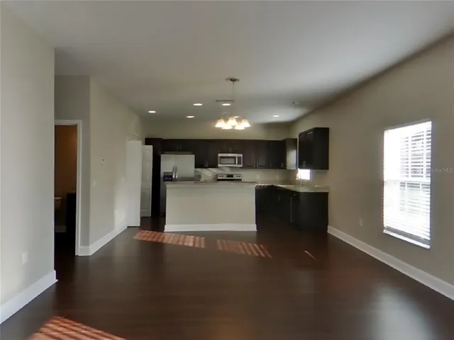 a view of kitchen with cabinets and wooden floor