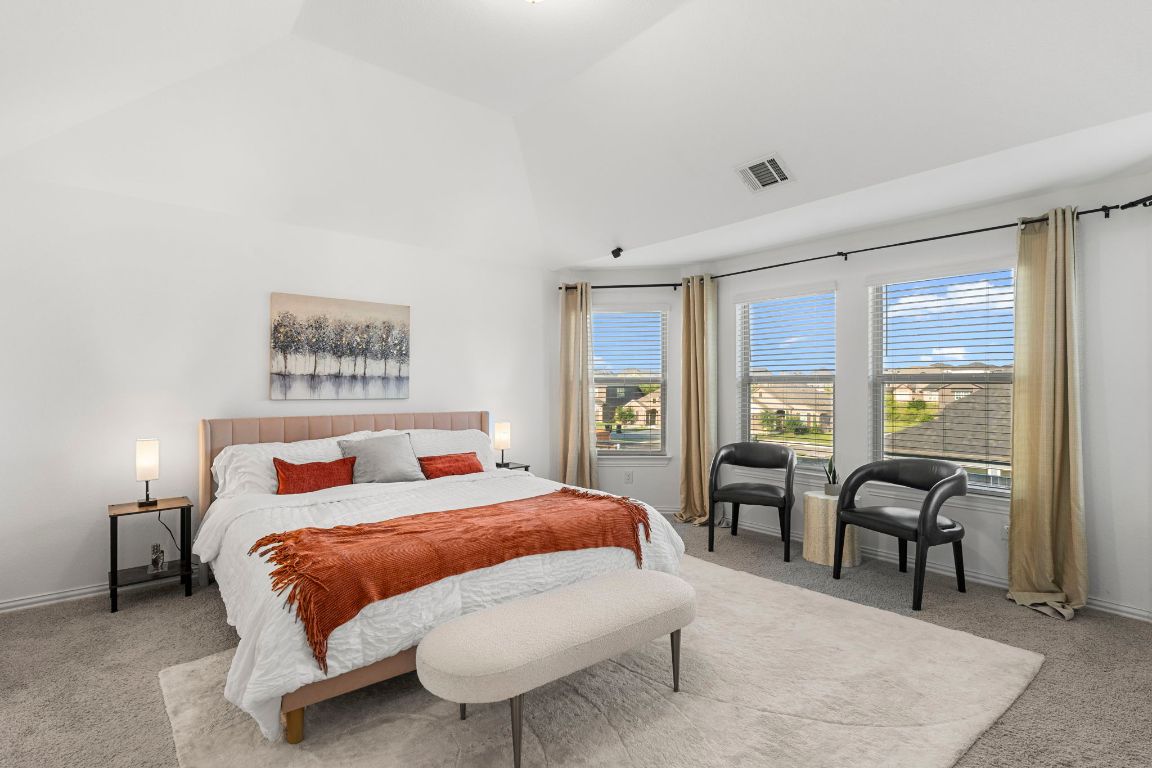 463 Oleander Loop Buda, TX 78610 - Photo 12 of 34 Carpeted bedroom with baseboards and high vaulted ceiling