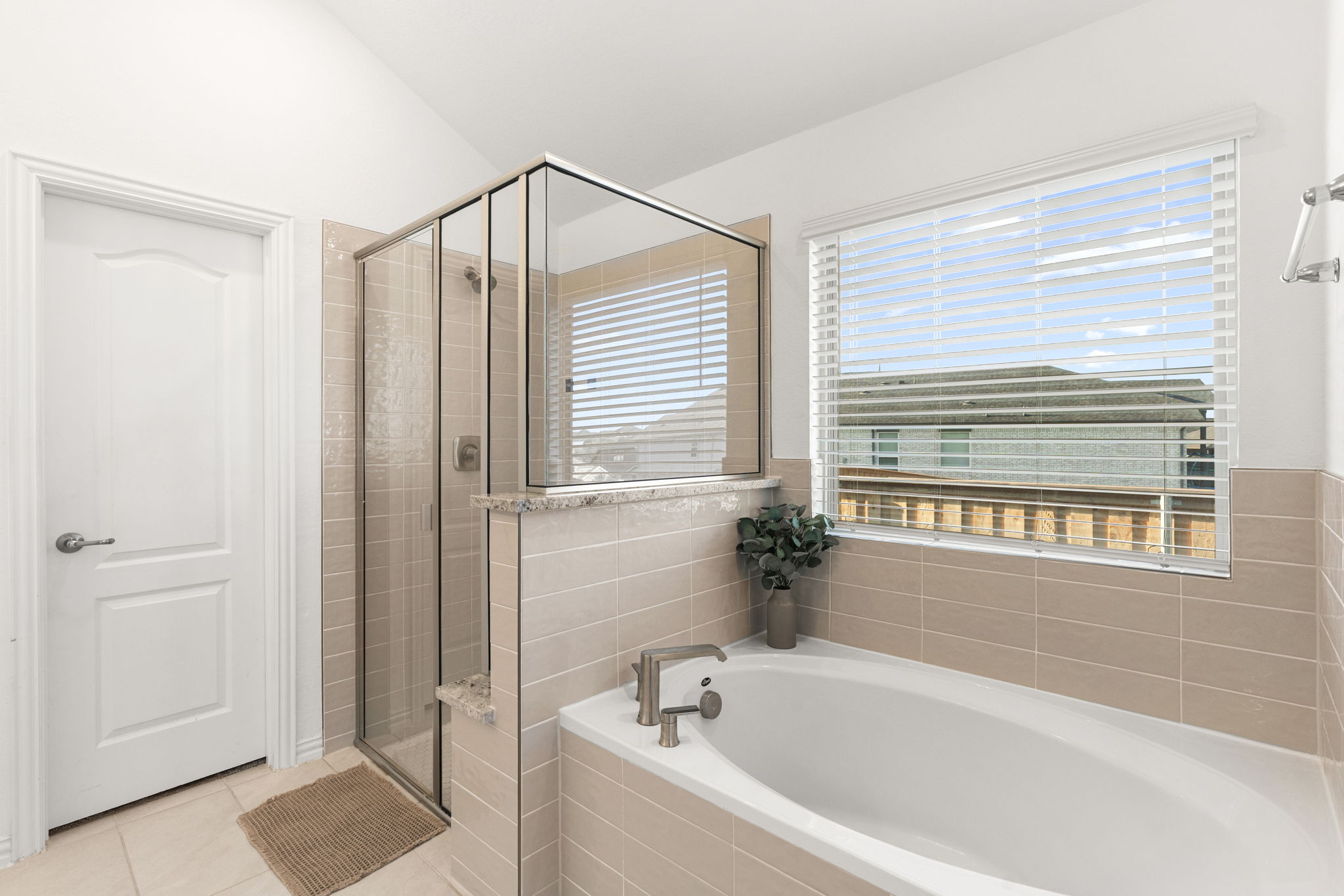 463 Oleander Loop Buda, TX 78610 - Photo 15 of 34 a bathroom with a bathtub and a shower