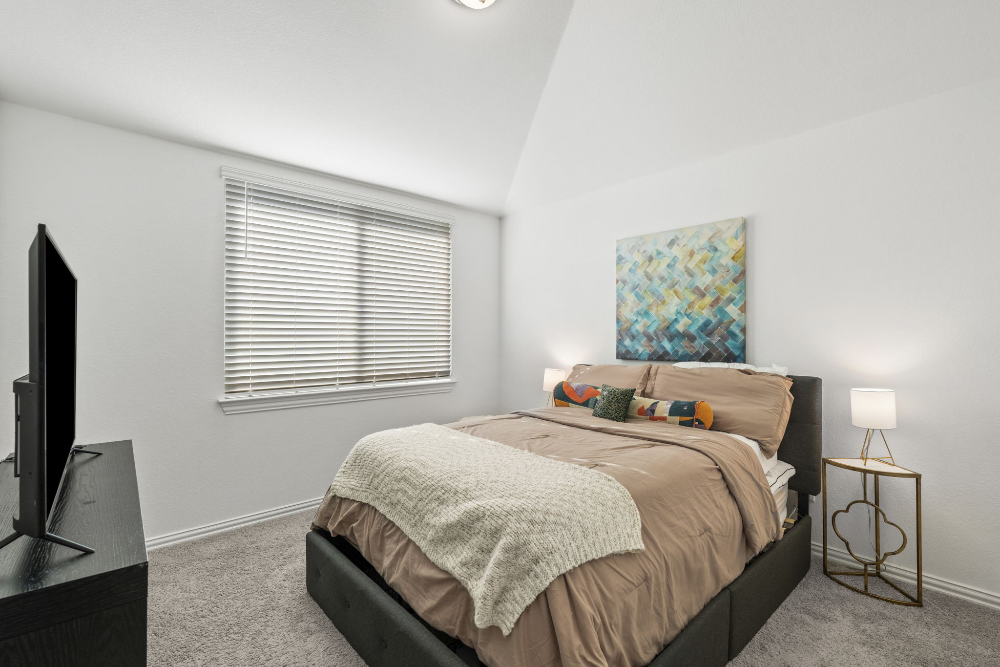 463 Oleander Loop Buda, TX 78610 - Photo 21 of 34 a bedroom with a bed and a flat tv screen on a dresser