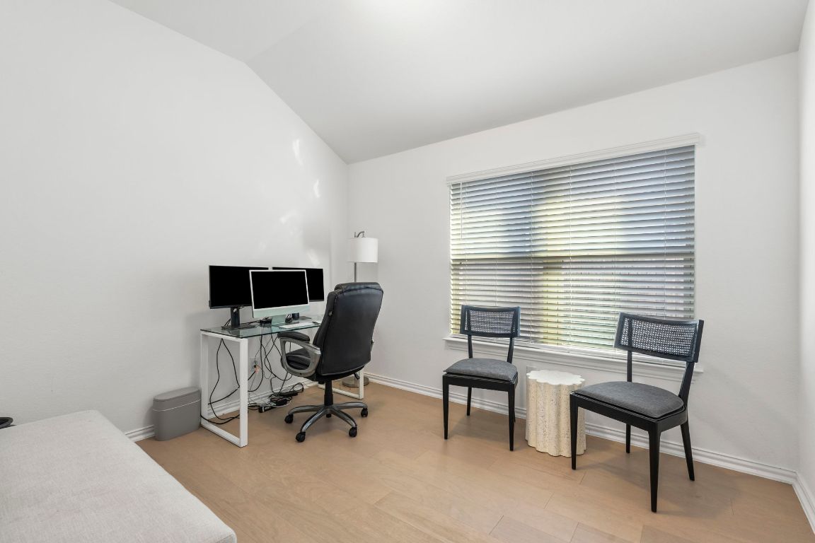 463 Oleander Loop Buda, TX 78610 - Photo 25 of 34 Office area with lofted ceiling and light wood-type flooring