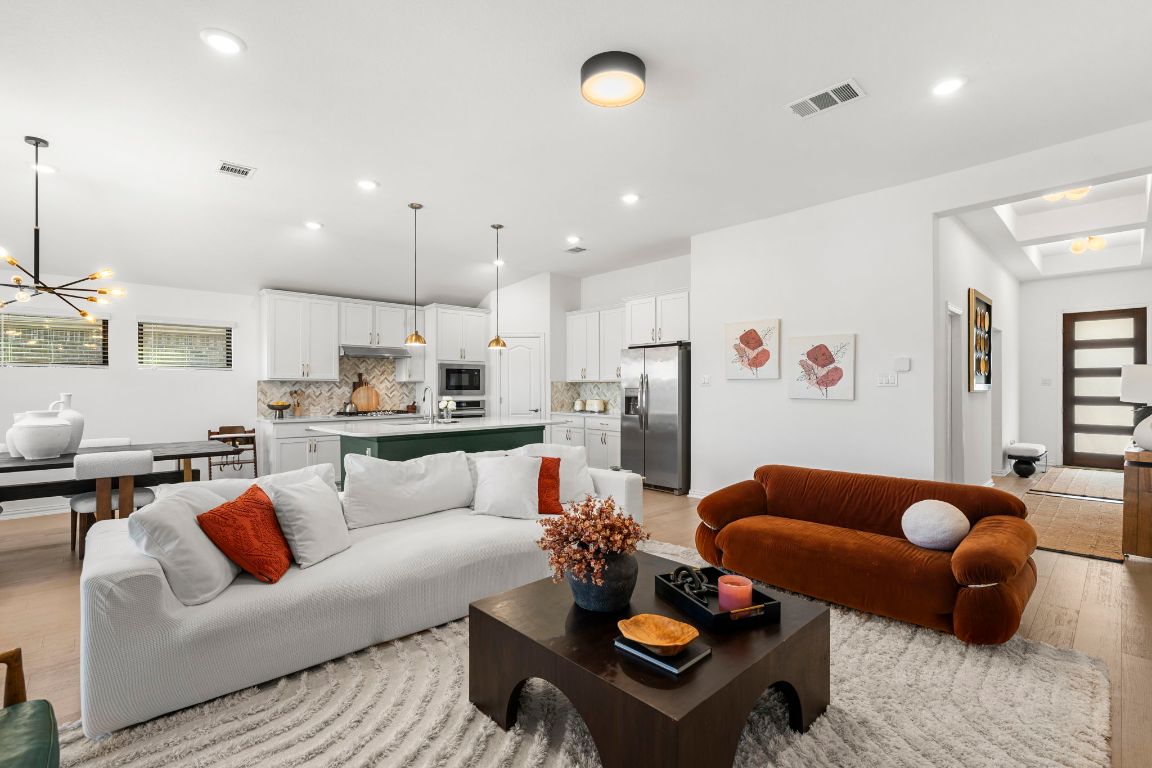 463 Oleander Loop Buda, TX 78610 - Photo 8 of 34 Living room with light wood finished floors, a chandelier, and recessed lighting