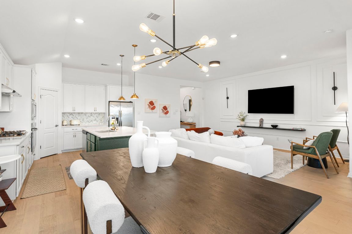 463 Oleander Loop Buda, TX 78610 - Photo 9 of 34 Dining room with light wood finished floors, recessed lighting, a chandelier, and a decorative wall